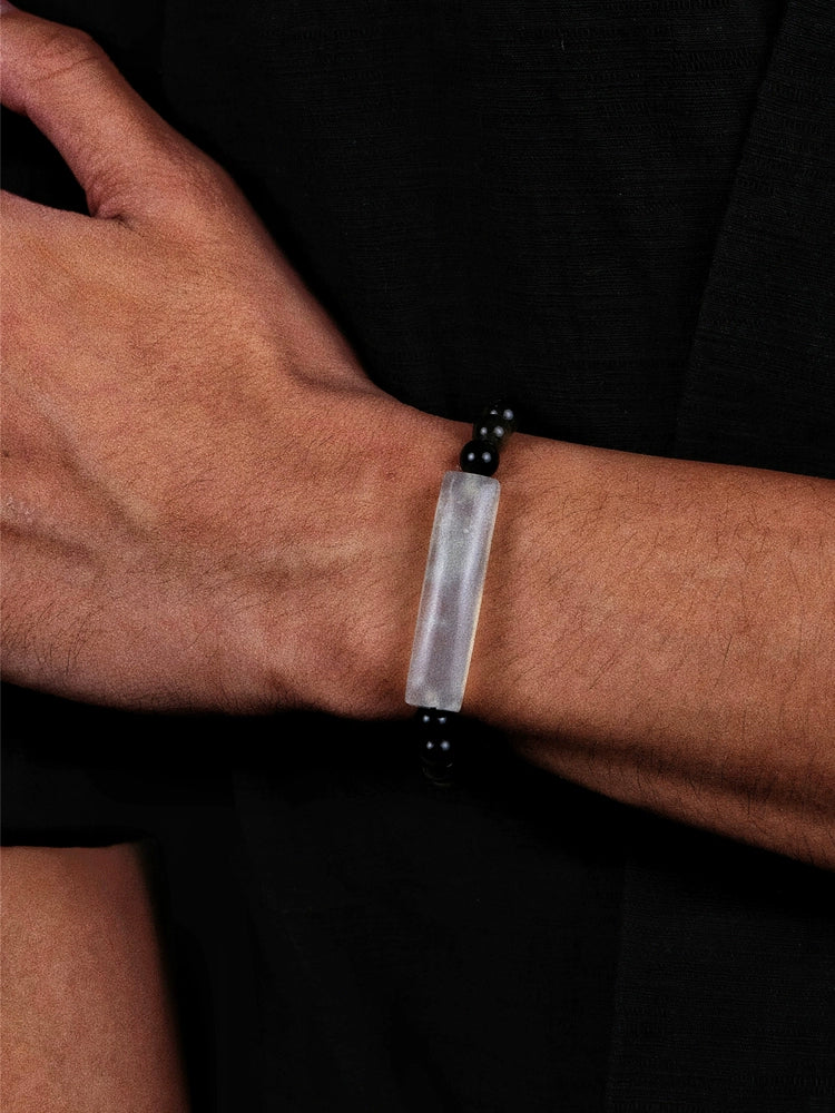 Silver and black beaded bracelet with a rectangular stone centerpiece