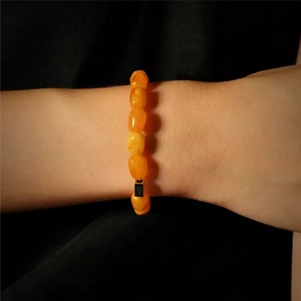 Orange beaded bracelet with black clasp