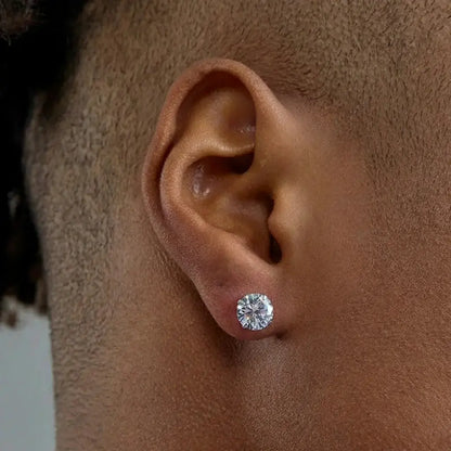 Diamond stud earrings with a shiny, clear gemstone and gold setting