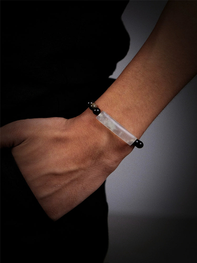 White and black beaded bracelet with silver accents