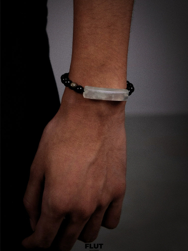 White stone and black bead bracelet with a minimalist design
