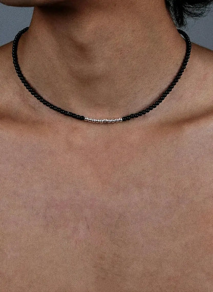 Black beaded necklace with silver accents, minimalist design