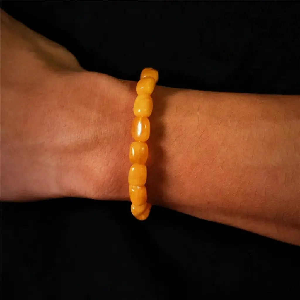 Yellow beaded bracelet with a smooth, glossy finish