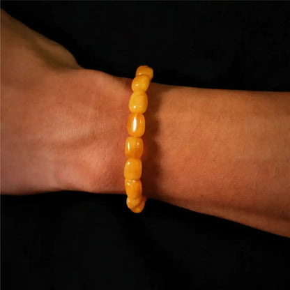 Yellow beaded bracelet with a smooth, glossy finish