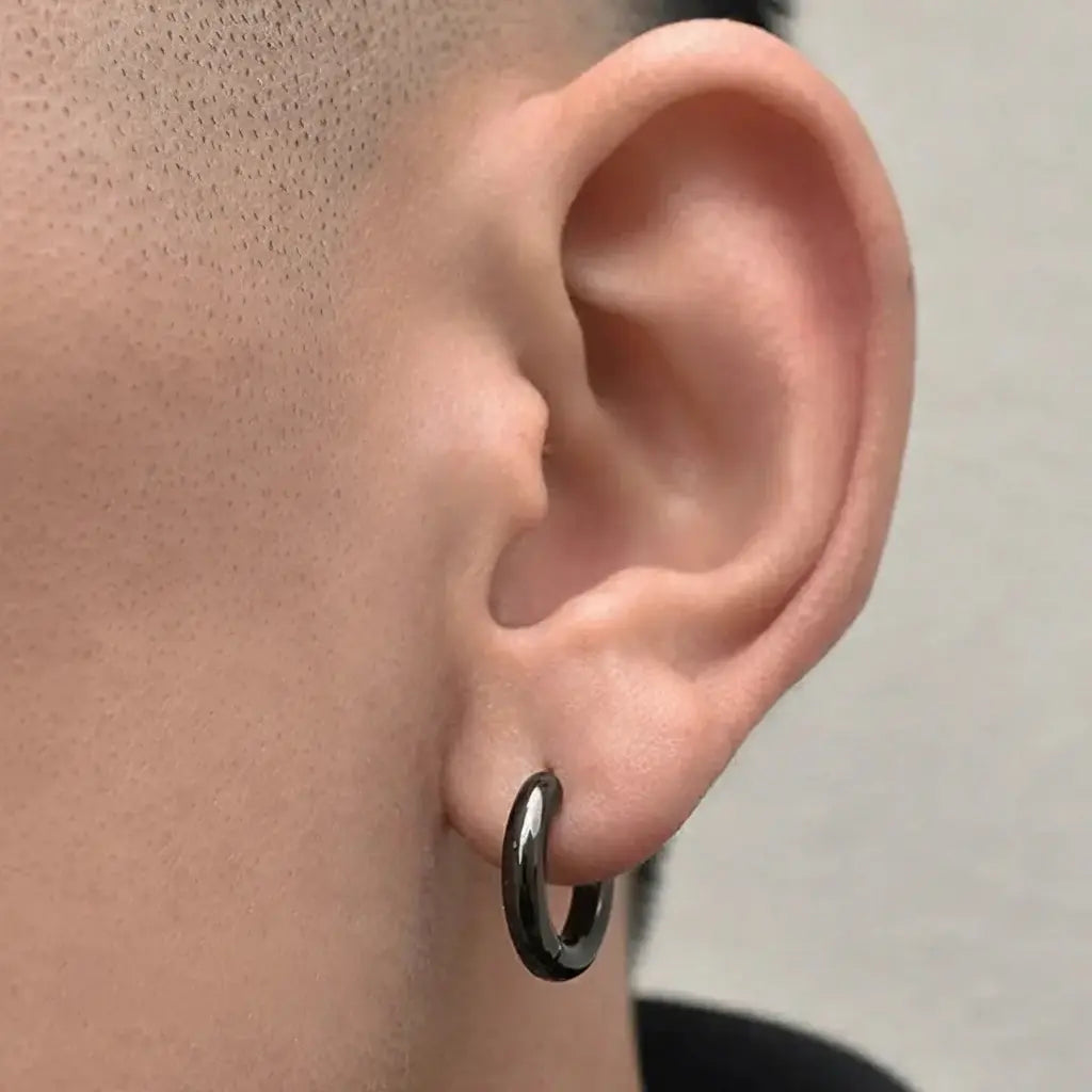 Black hoop earring with a matte finish and silver accents